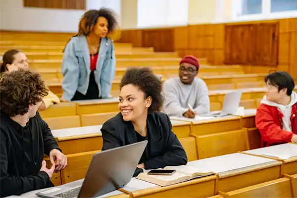 A diverse group of students engaging in discussion inside a college lecture hall.(Image: Yan Krukau via Pexels.com)